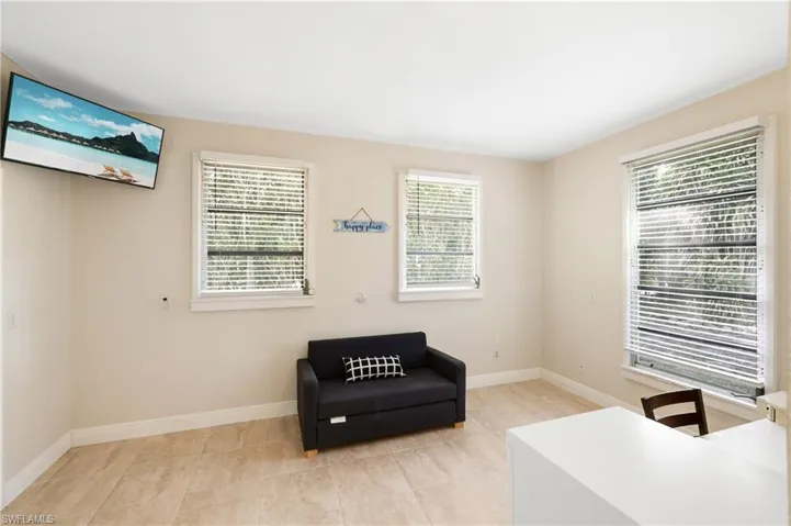 Sitting room with light tile patterned floors and plenty of natural light