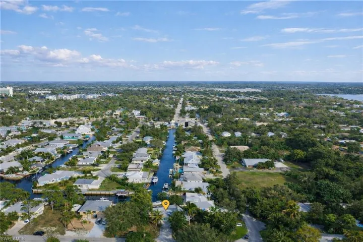 Aerial overview of property's location featuring nearby suburban area and a large body of water
