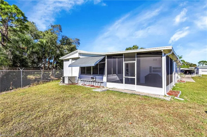 Rear view of property featuring a sunroom
