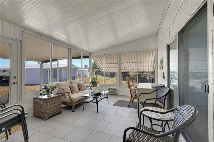 Sunroom / solarium with an outdoor living space and vaulted ceiling