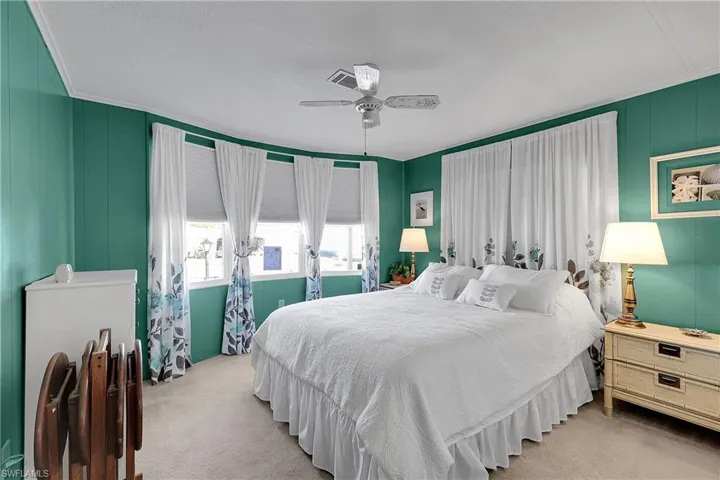 Bedroom with a ceiling fan and carpet flooring