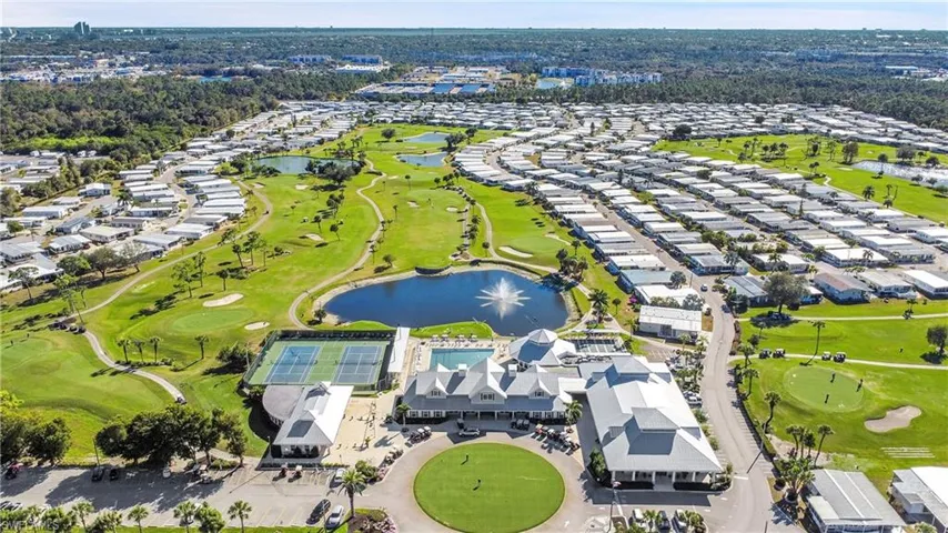 Aerial view of residential area with a golf course and a large body of water
