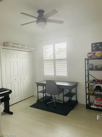 Home office featuring light wood-style flooring and ceiling fan