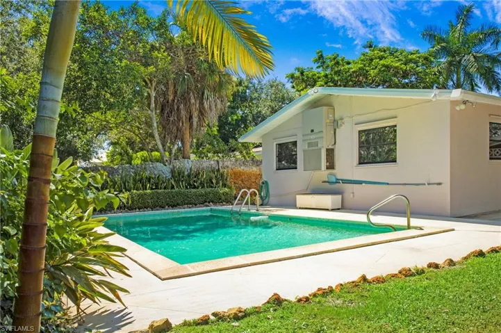 14-28 pool rear of home  with tropical landscaping