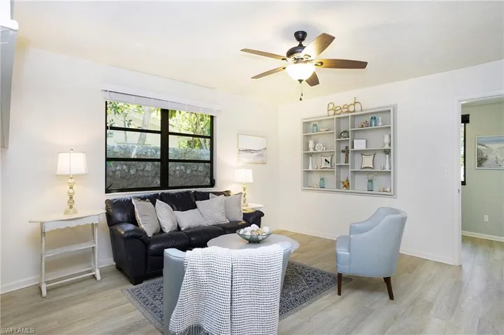 Living room featuring ceiling fan and light luxury vinyl wood-style flooring