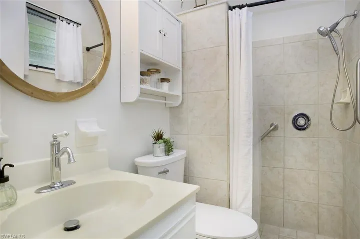 Master Bathroom featuring a shower with shower curtain, vanity, and toilet