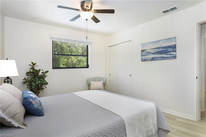 Master Bedroom featuring a closet, light wood-style luxury flooring, and ceiling fan