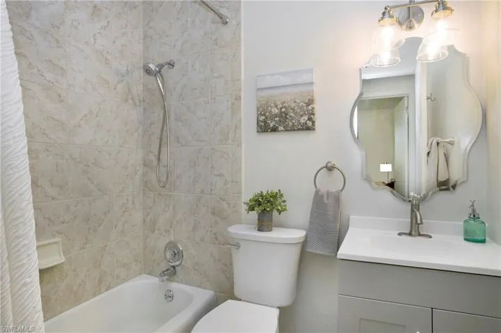 Full bathroom with shower / tub combo, oversized vanity, and toilet