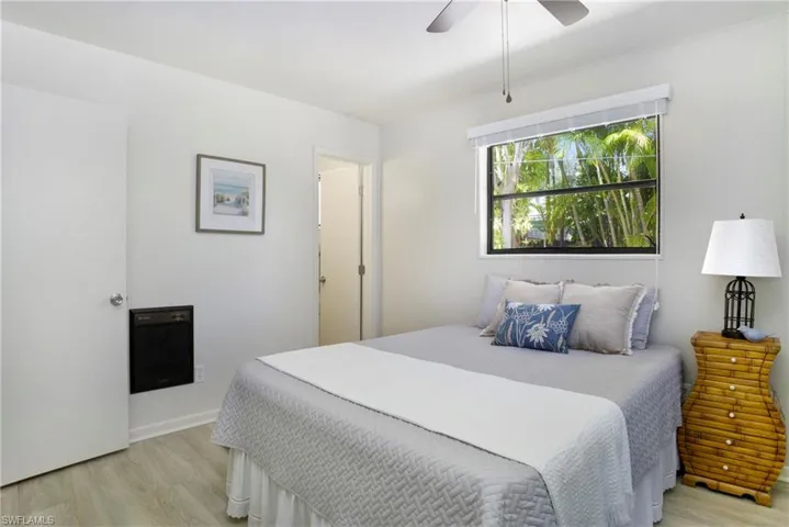 Master Bedroom with ceiling fan and light luxury vinyl wood-style flooring