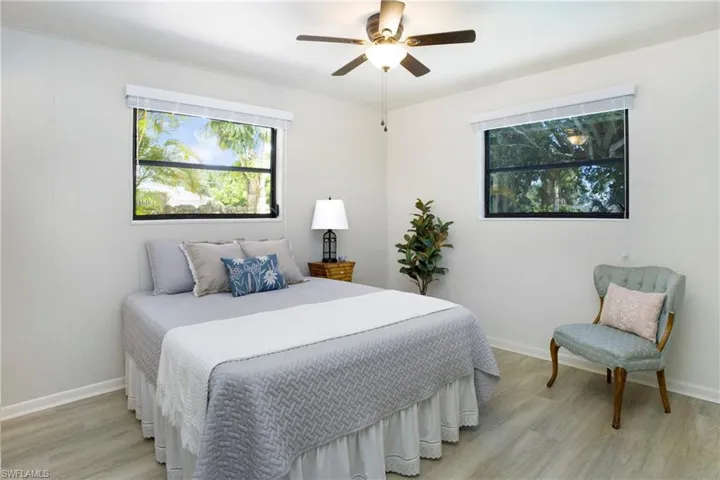 Master Bedroom with ceiling fan and light luxury vinyl wood-style flooring