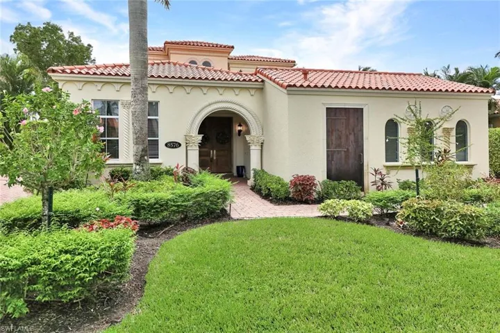 Mediterranean / spanish-style home with a front yard