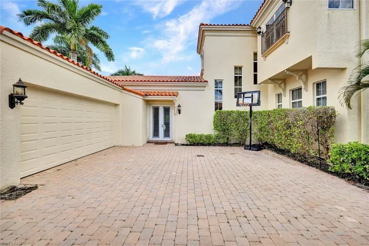 Double garage is tucked in the back of the home and provides added play area