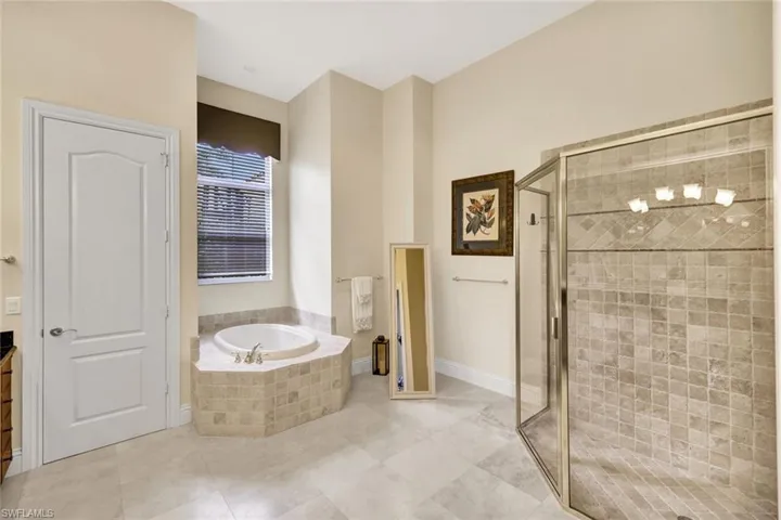 Bathroom featuring walk in shower and tile patterned flooring