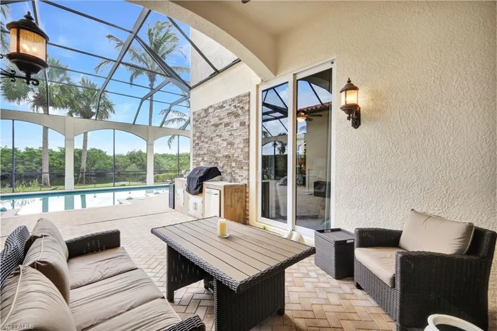 Covered sitting area on lanai with outdoor kitchen
