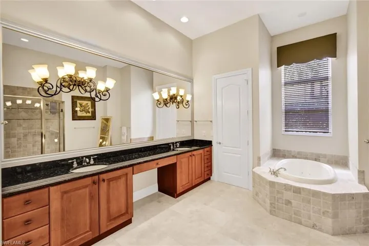 Bathroom with dual sinks and soaking tub