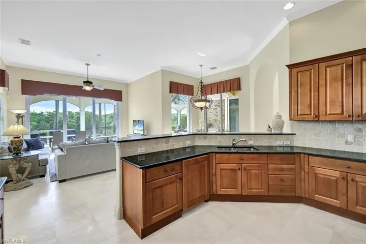 Kitchen flowing into the great room a gorgeous view of the backyard