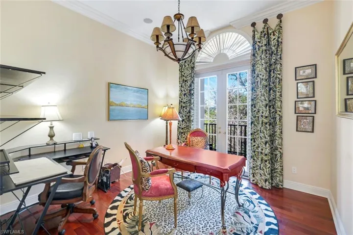 Laundry area featuring washer and dryer, cabinet space, ornamental molding, and baseboards