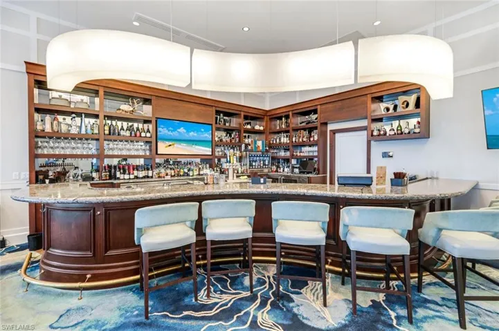View of front of house featuring stucco siding, decorative driveway, an attached garage, and a balcony
