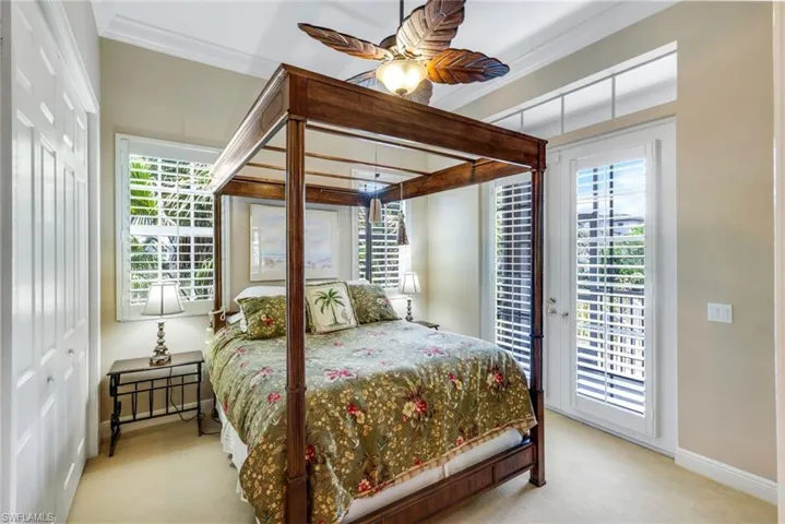 Full bath with healthy amount of natural light, enclosed tub / shower combo, vanity, and toilet