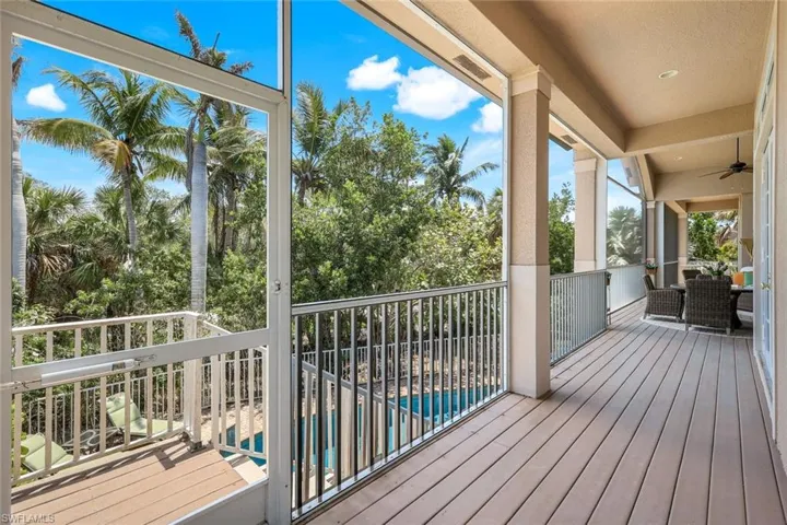 Wooden deck featuring an outdoor living space, ceiling fan, and an outdoor pool