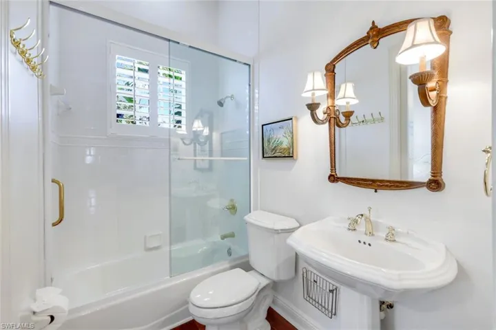 Office area featuring baseboards, wood finished floors, a chandelier, and ornamental molding