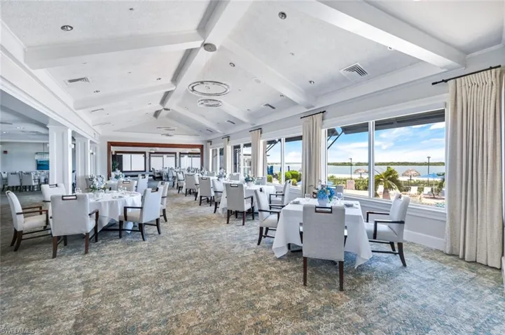Dining space with carpet floors, healthy amount of natural light, and a water view