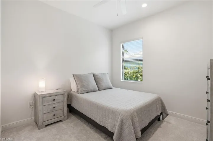 Bedroom featuring a window with blinds, recessed lighting, a ceiling fan, and light-colored carpeting