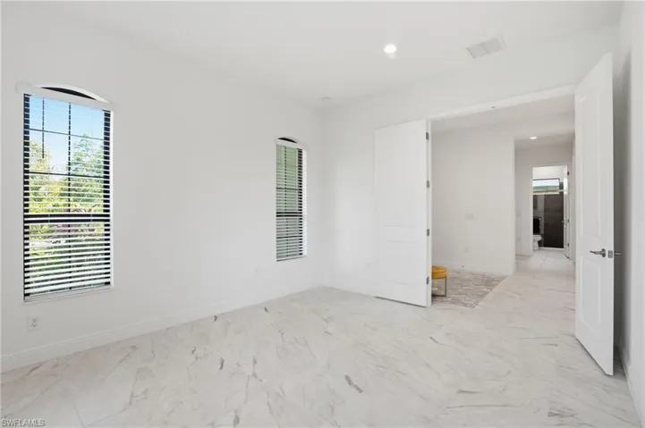 Bright interior space with white walls and large-format tile flooring
