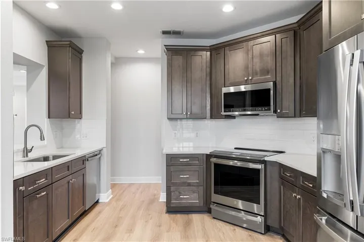 Beautful 42" wood cabinetry, stainless steel GE PROFILE appliances, white subway tile backsplash.