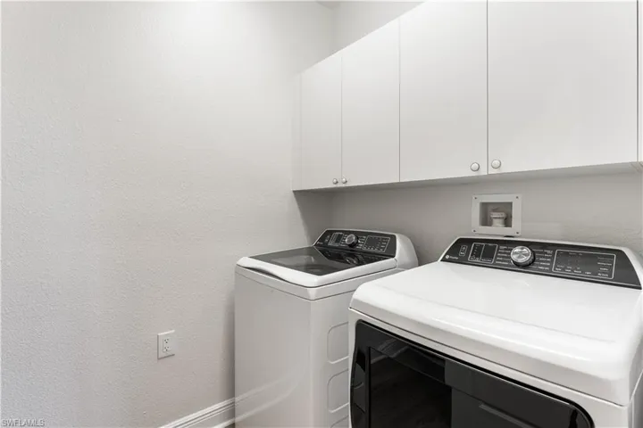 Laundry room offers more storage.