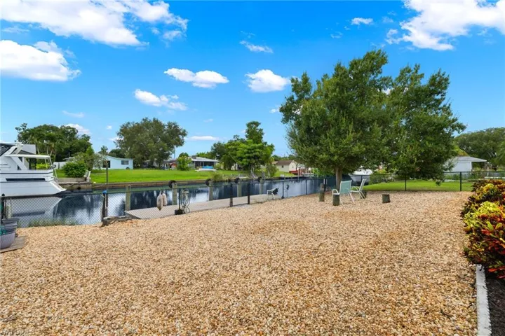 View of fenced in yard featuring a water view