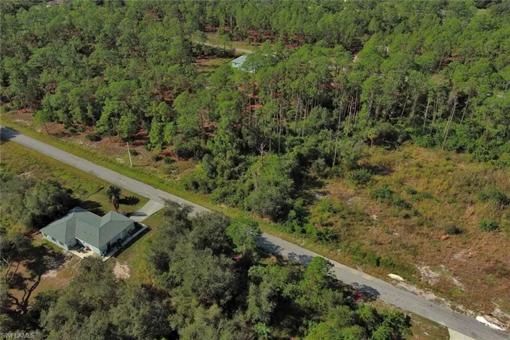 Aerial overview of property's location featuring a forest