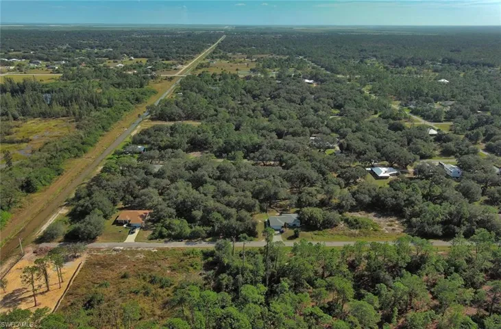 View of property location with a heavily wooded area