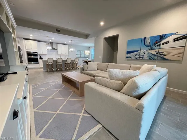Living room featuring recessed lighting and a chandelier