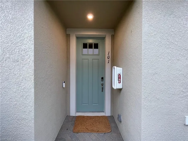 Property entrance featuring stucco siding