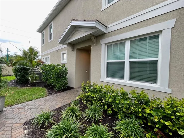 Property entrance with stucco siding