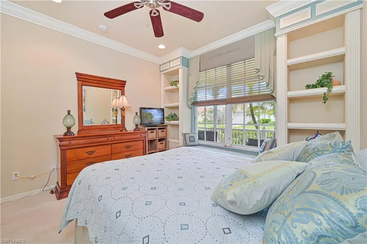 Carpeted bedroom featuring crown molding, a ceiling fan, and recessed lighting