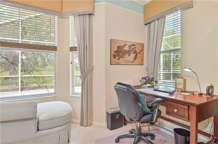 Home office with light carpet and ornamental molding