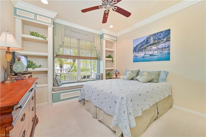 Bedroom with ornamental molding, light carpet, a ceiling fan, and recessed lighting