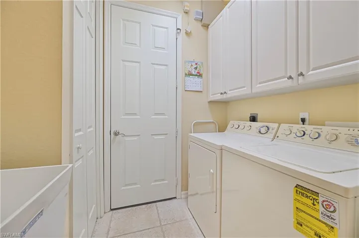 Laundry room featuring cabinet space and washer and clothes dryer