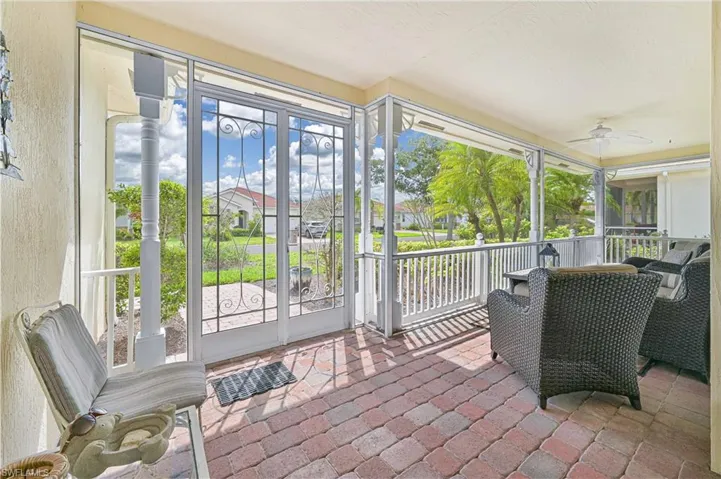 Sunroom / solarium featuring ceiling fan, plenty of natural light, and french doors