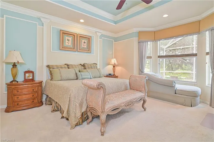 Bedroom with crown molding, carpet, recessed lighting, a raised ceiling, and ceiling fan