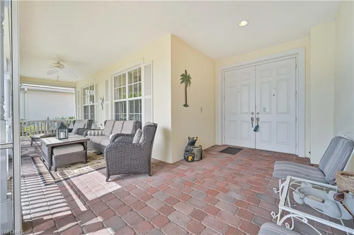 View of patio with a ceiling fan, outdoor furniture, and a sunroom