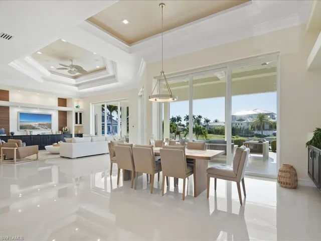Dining space with crown molding, a raised ceiling, recessed lighting, and ceiling fan