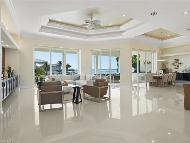 Lobby featuring recessed lighting, a tray ceiling, and a water view