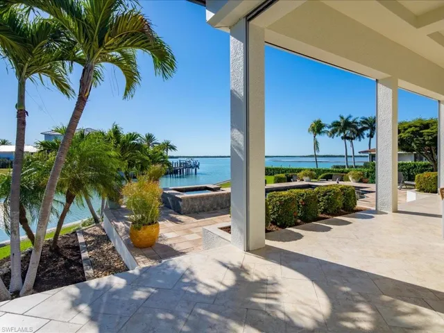 View of patio / terrace with a water view and an in-ground hot tub