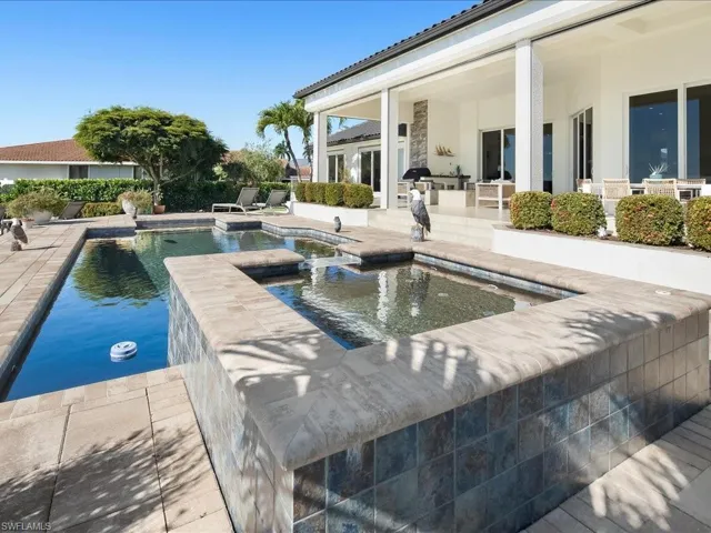 Integrated pool / hot tub featuring a patio
