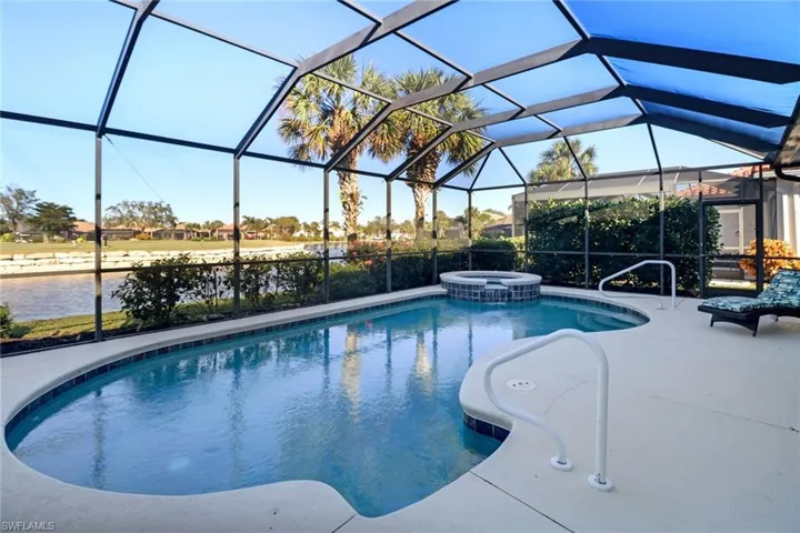 View of pool with a water view, a patio area, and a lanai