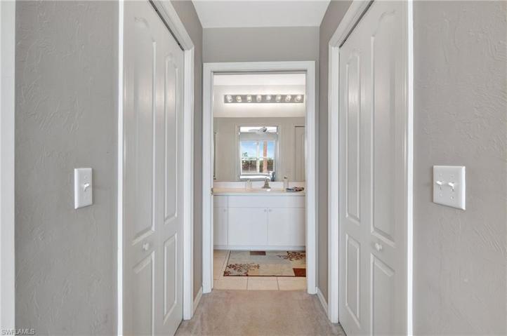 Walk in closets on either side of hall to private bath