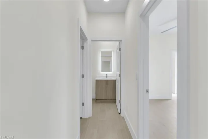Hallway featuring baseboards and light wood-style flooring